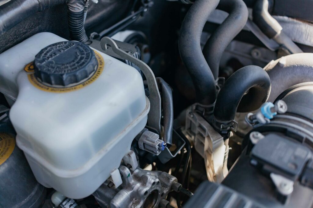 Engine coolant reservoir under the hood