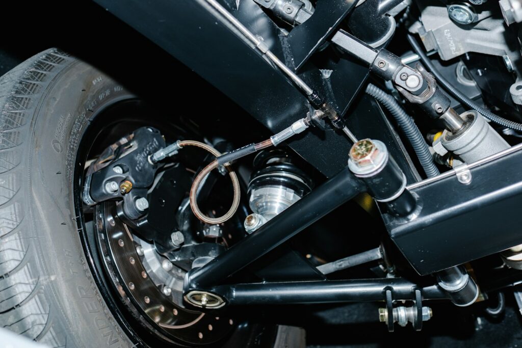 Suspension strut and steering parts behind a wheel